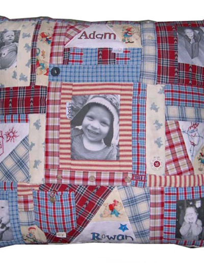 Memory cushion made from child’s old clothing and featuring transferred photographs and hand-embroidered facsimiles of child’s artwork