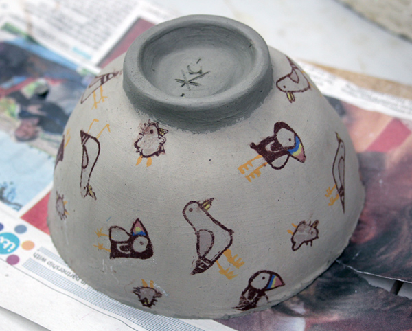 Slip cast bowl decorated with screen printed transfers. Ready for firing.