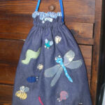 Lined drawstring pump bag appliqued with insects