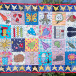 Pippin’s quilt- machine appliqued and pieced quilt used as end paper design