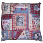 Memory cushion made from child’s old clothing and featuring transferred photographs and hand-embroidered facsimiles of child’s artwork