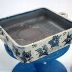 Slab-formed casserole dish decorated with hand drawn slip transfers