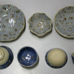 Press-moulded plates and slip cast bowls all slip decorated and glazed